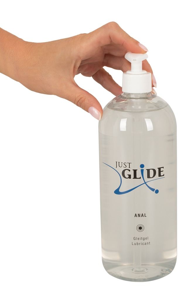 Main tenant un flacon transparent avec pompe doseuse. Inscription: JUST GLIDE ANAL. Gleitgel Lubricant.