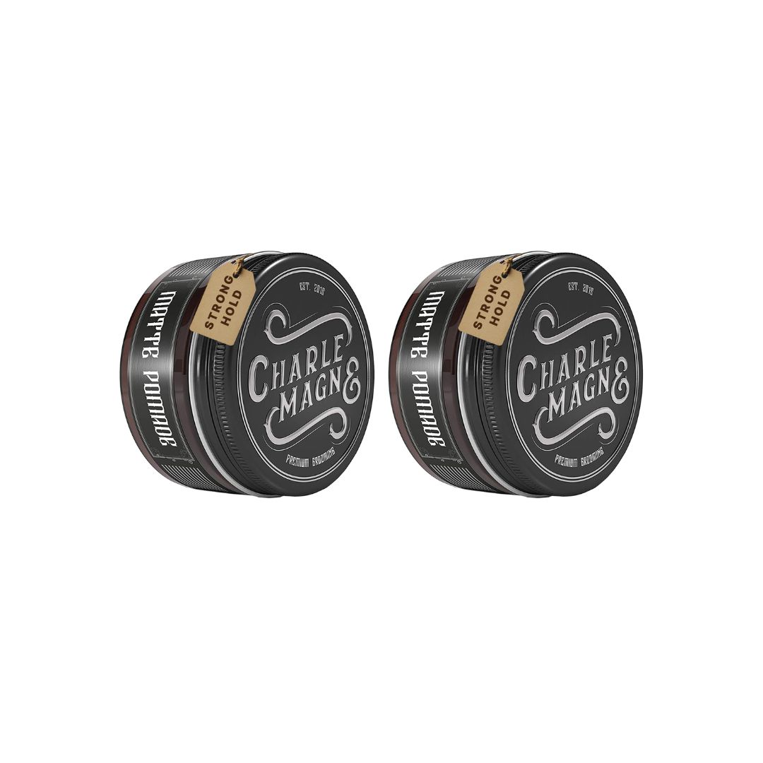 Twee ronde blikken met zwarte deksels en bruine randen. Opschrift "Charlemagne" en "Matte Pomade". Label met "Strong Hold".