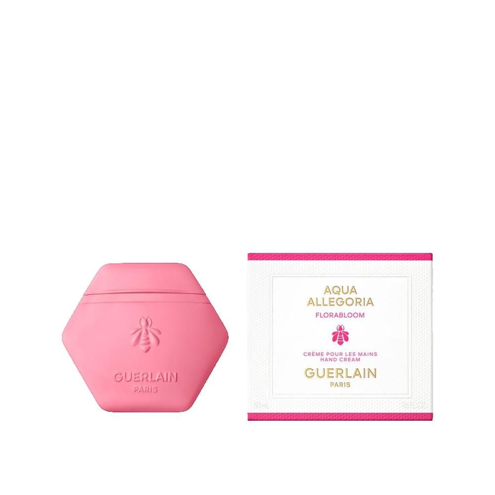 Contenant rose en forme d'hexagone pour crème pour les mains, logo abeille et texte. Boîte blanche à côté avec texte.