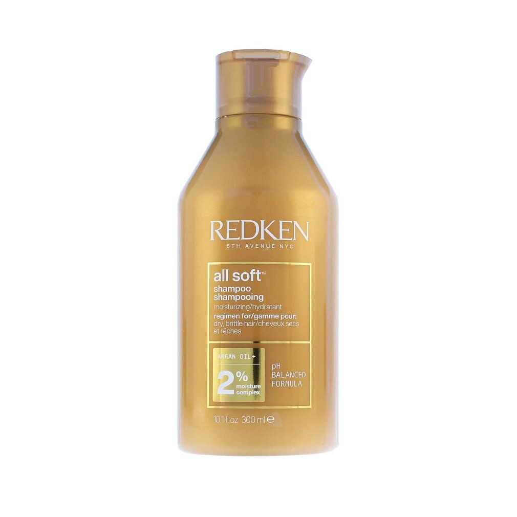 Gouden shampoo fles. Opschrift: Redken, all soft, shampoo. Bevat arganolie en 2% vochtcomplex. pH-gebalanceerd.