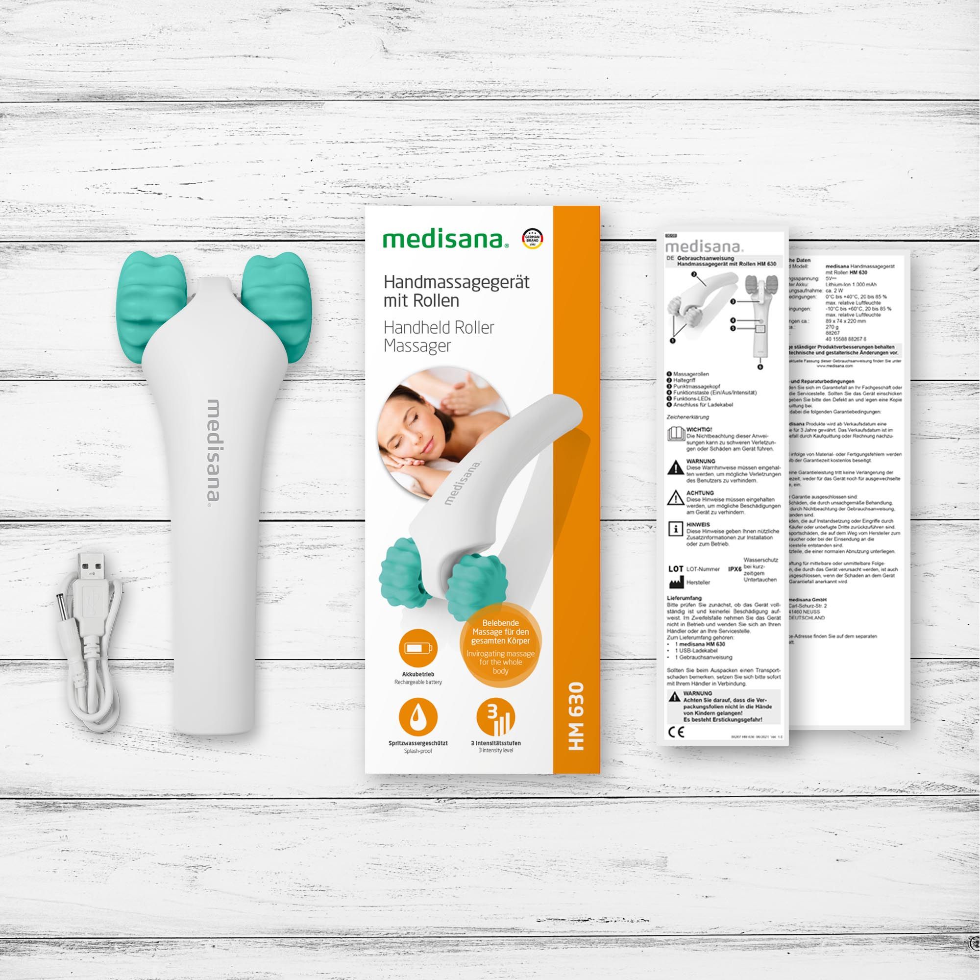 Medisana handmassageapparaat HM 630, wit met turquoise rollen, inclusief oplaadkabel en verpakking.