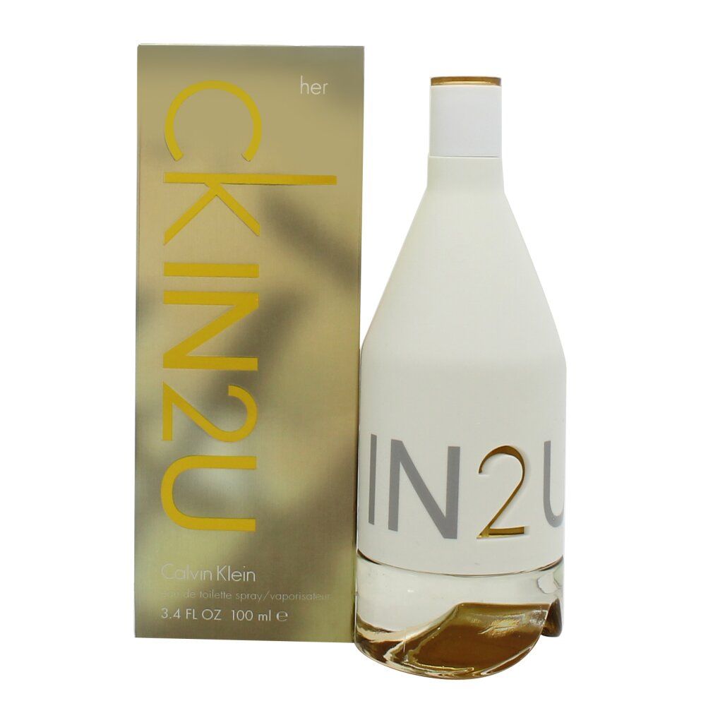 Parfumfles en verpakking. Witte, cilindrische fles met zilveren belettering. Gouden verpakking met gele belettering.