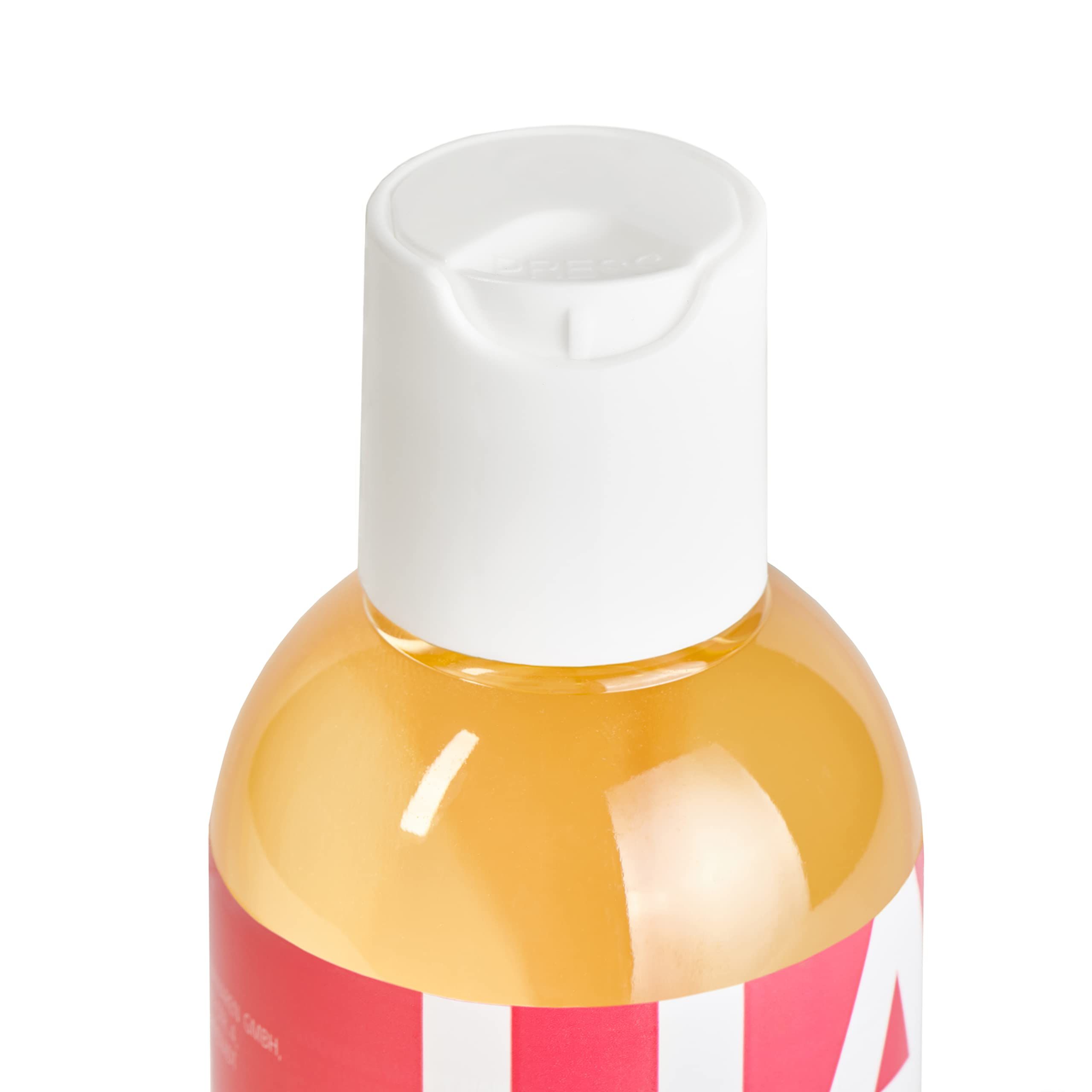 Fles Loovara Happy Hand massageolie met rood label en witte letters, omringd door oliespatten.