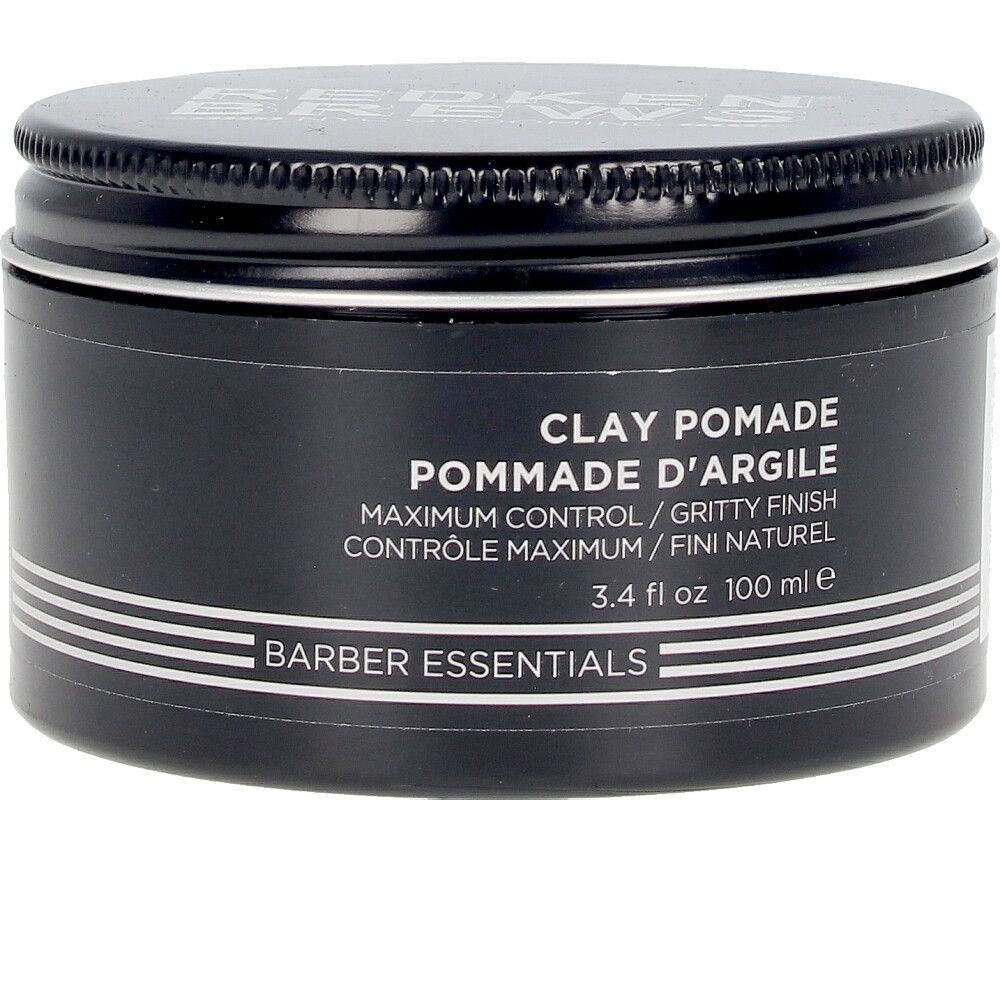 Pot noir avec couvercle. Inscription: Clay Pomade, Pommade d'Argile, Barber Essentials. 3.4 fl oz 100 ml.