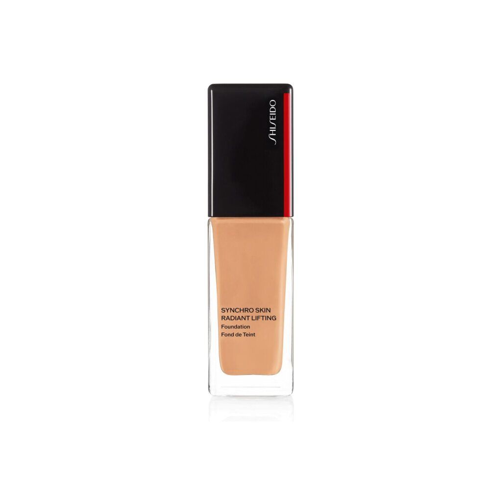 Flacon de fond de teint. Bouchon noir avec bande rouge. Inscription: Synchro Skin Radiant Lifting Foundation. Teinte.