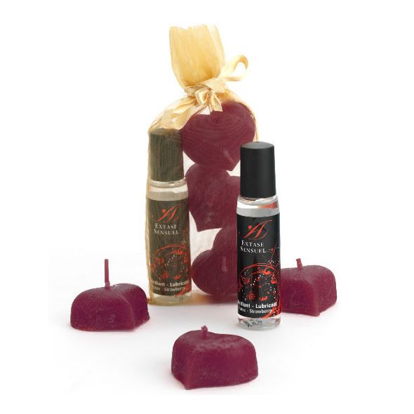 Set massageolie flesjes en hartvormige kaarsen in een geschenktas.