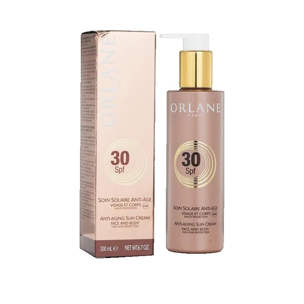 Flacon et emballage de crème solaire. Inscription : Orlane Paris, SPF 30. Crème solaire anti-âge visage et corps. 200 ml.