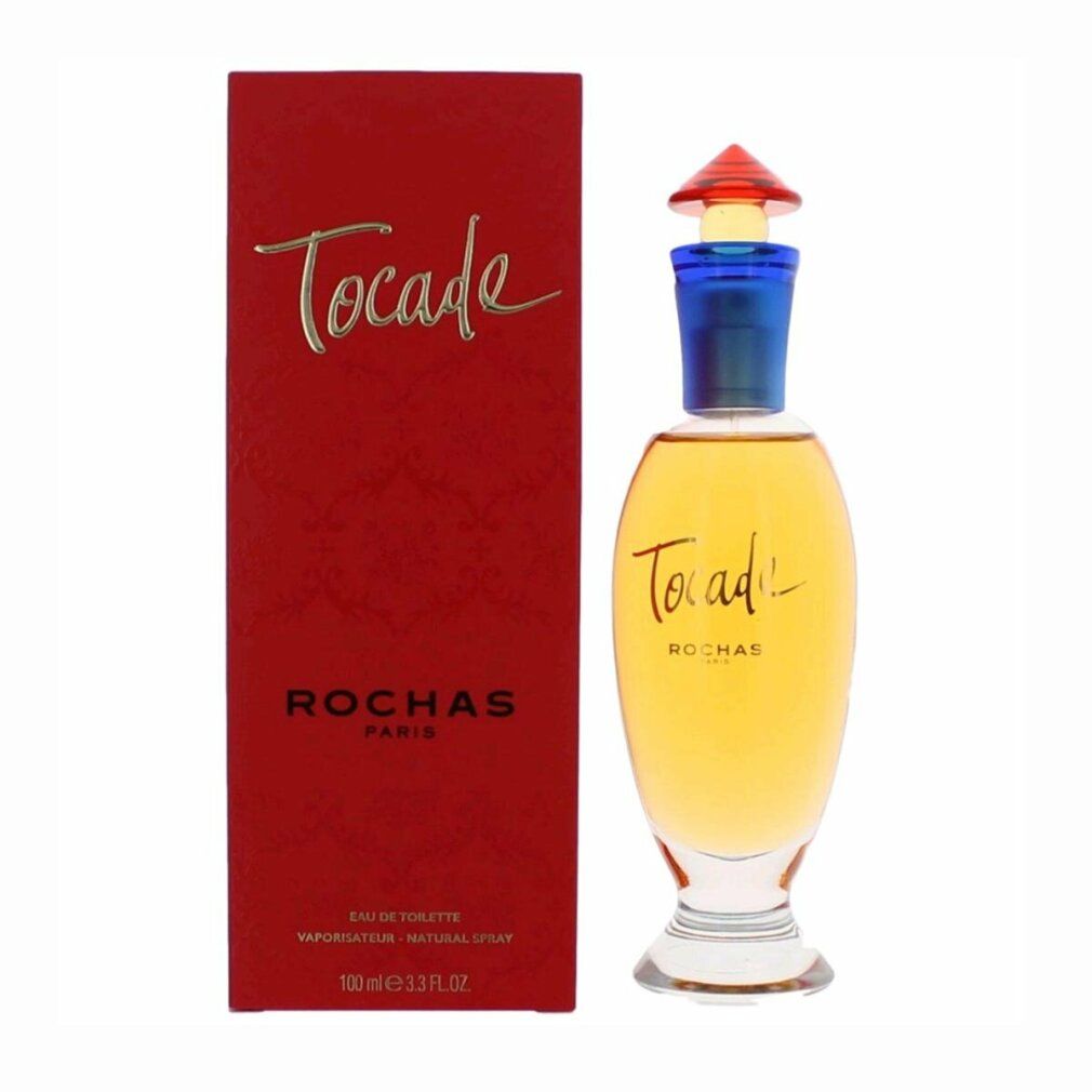 Emballage rouge et flacon de parfum. Inscription "TOCADE" et "ROCHAS PARIS". Flacon avec col bleu et bouchon rouge.