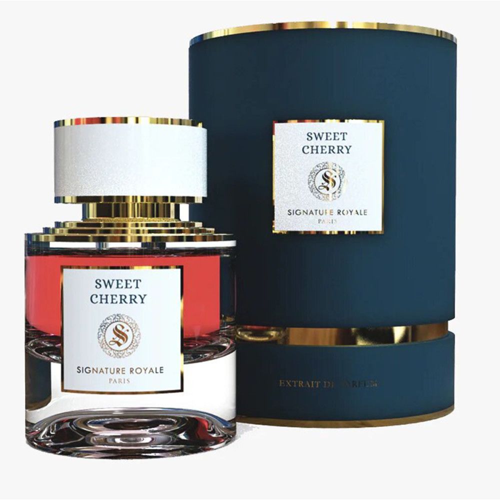 Flacon de parfum avec liquide rouge, détails dorés et bouchon blanc. Emballage bleu à bord doré et étiquette.