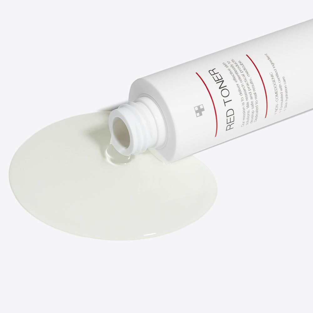 Flacon blanc renversé, liquide coulant. Inscription: RED TONER. Liquide formant une flaque.