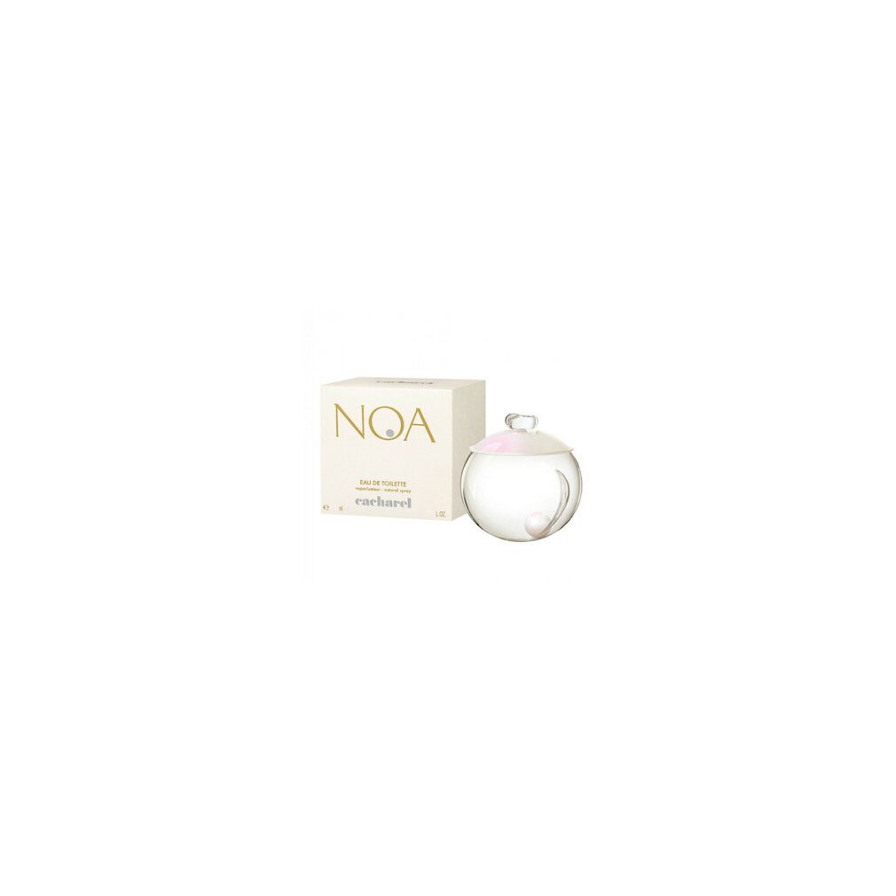 Flacon de parfum rond en verre avec bouchon et boîte. La boîte porte les inscriptions "NOA" et "cacharel".