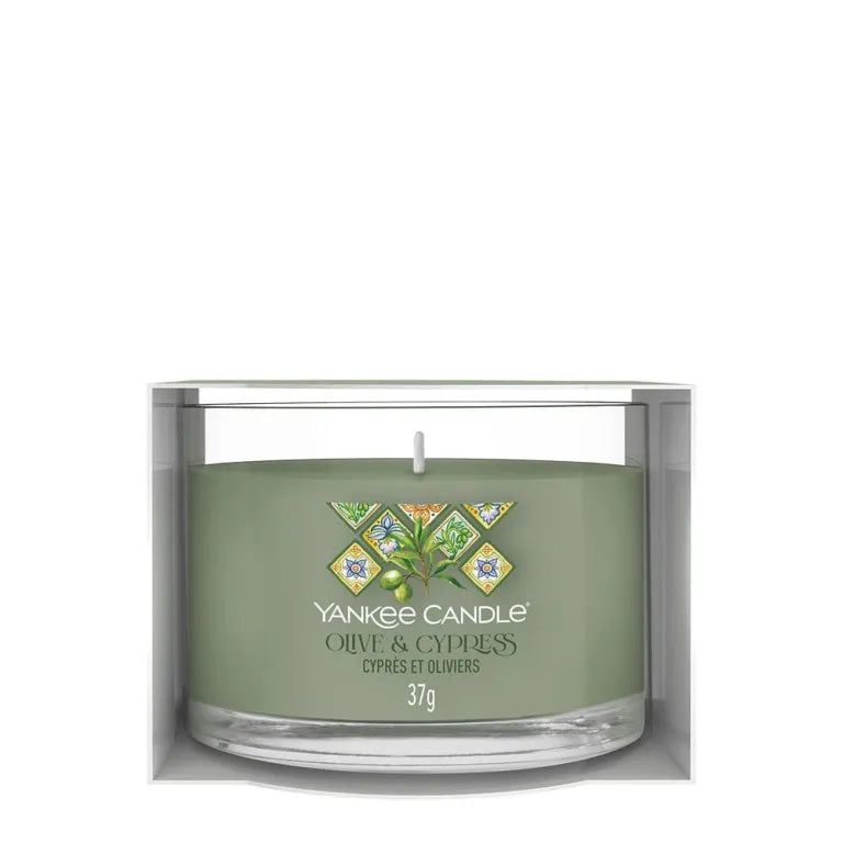 Bougie verte en verre et emballage. Inscription: Yankee Candle, Olive & Cypress, 37g. Bougie non allumée.