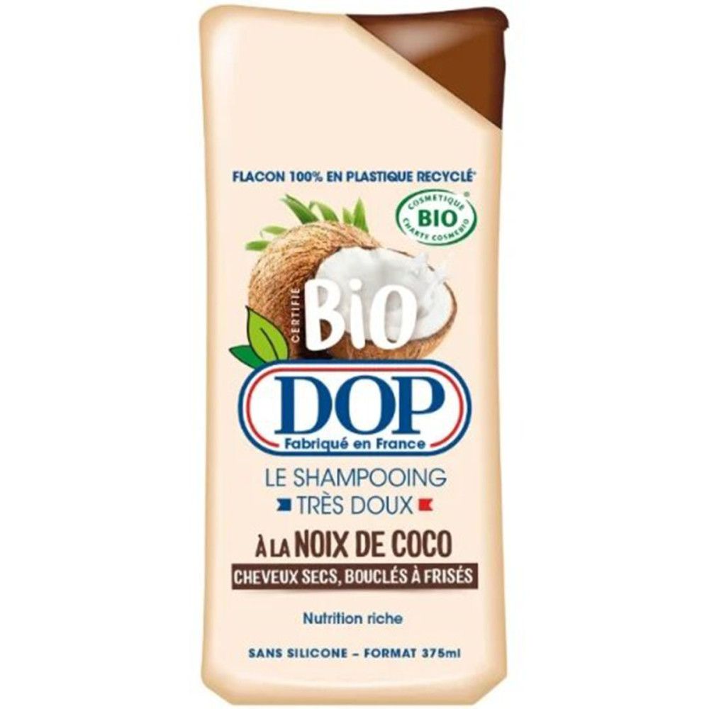 Beige shampoo fles met kokosnoot illustratie en tekst. DOP logo en Bio certificering. Tekst: À LA NOIX DE COCO, voor droog haar.