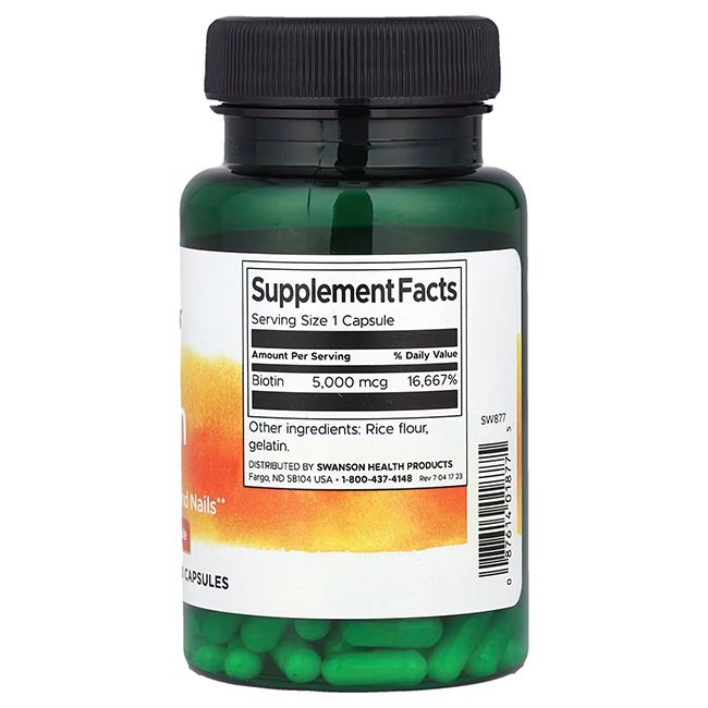 Capsules vertes dans un flacon vert. Inscription: SWANSON. Informations nutritionnelles: Biotine 5 000 mcg. Ingrédients: farine de riz, gélatine.
