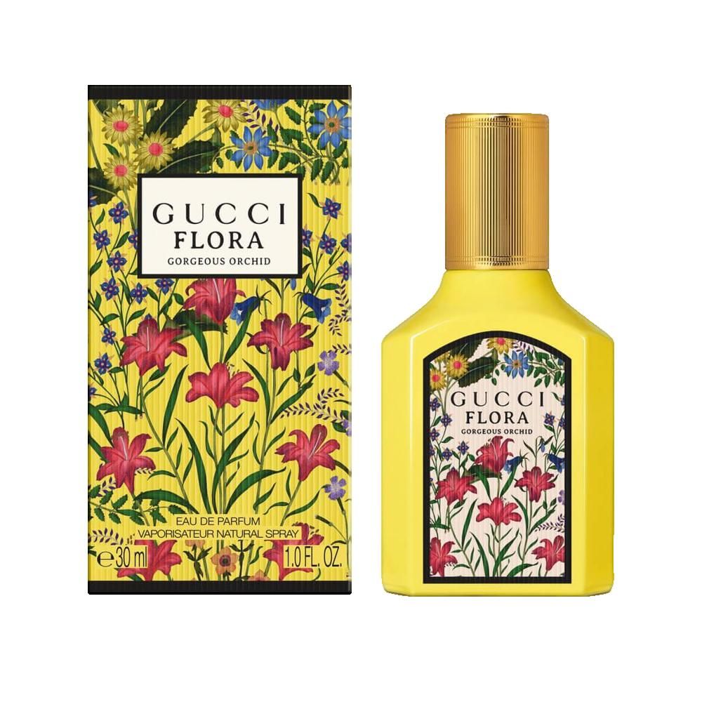 Flacon jaune et boîte. Flacon avec étiquette florale et bouchon doré. Boîte avec motif floral.
