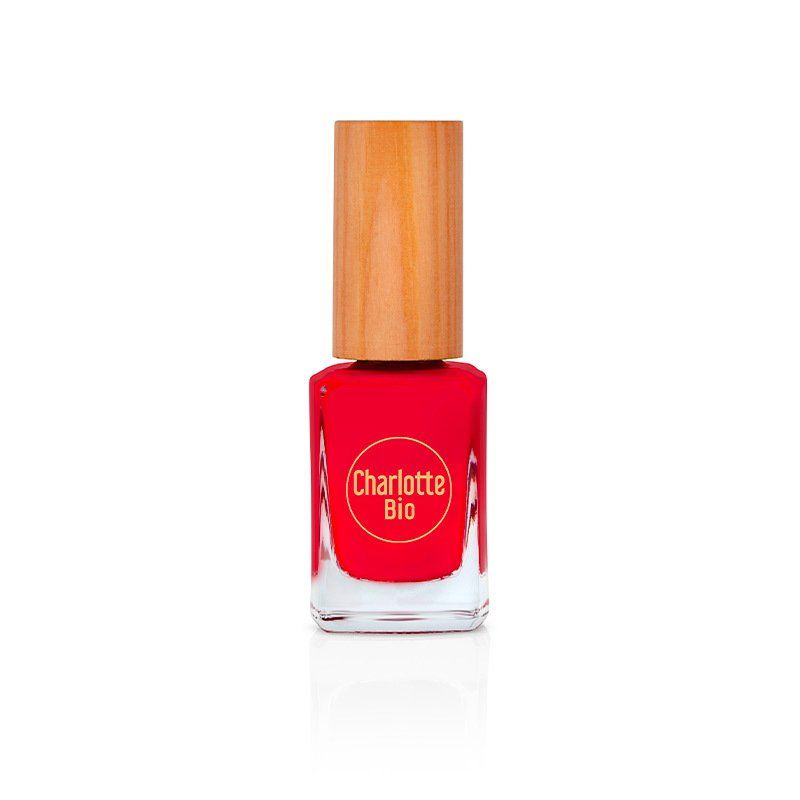 Flacon de vernis à ongles rouge avec bouchon en bois. Le flacon porte l'inscription "Charlotte Bio".