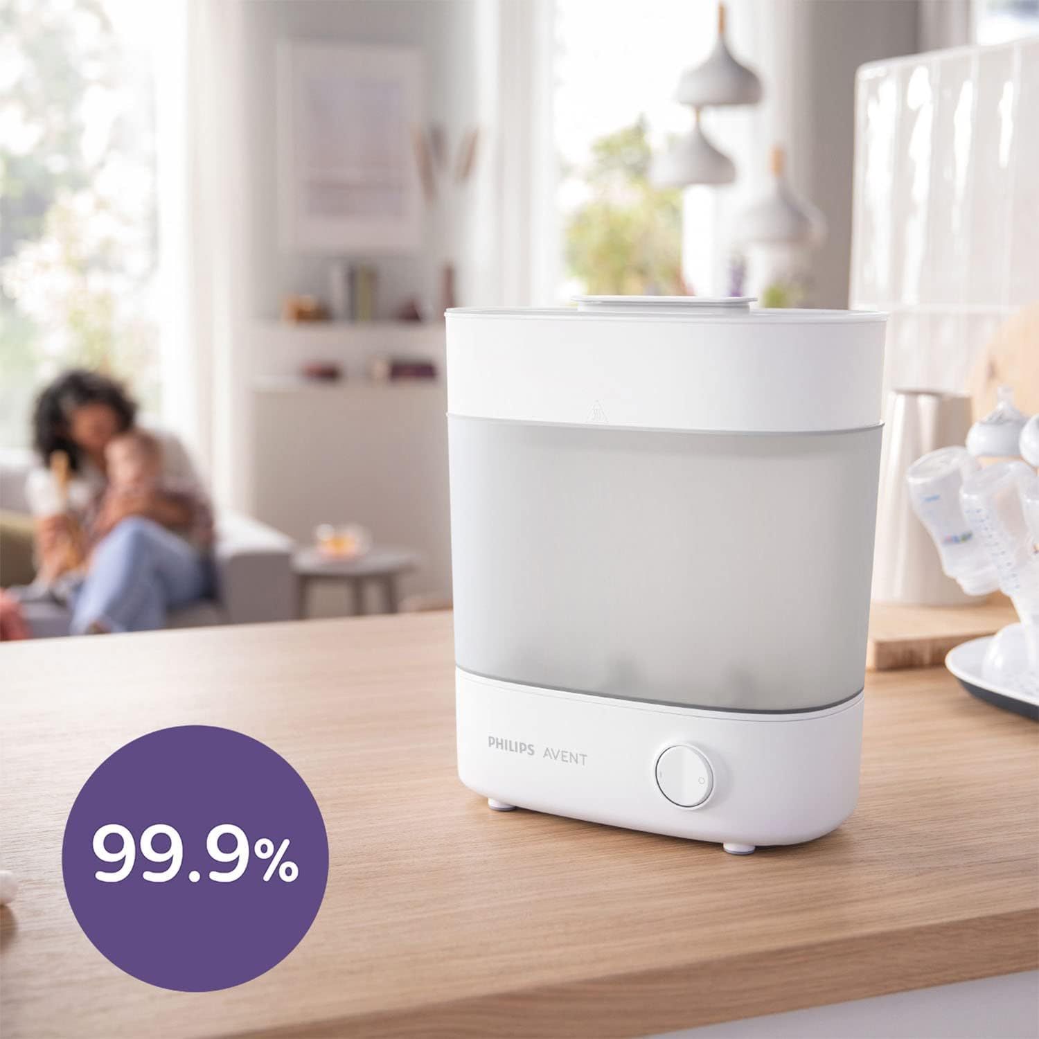 Stérilisateur Philips Avent sur un plan de travail, avec un cercle violet indiquant '99,9%.