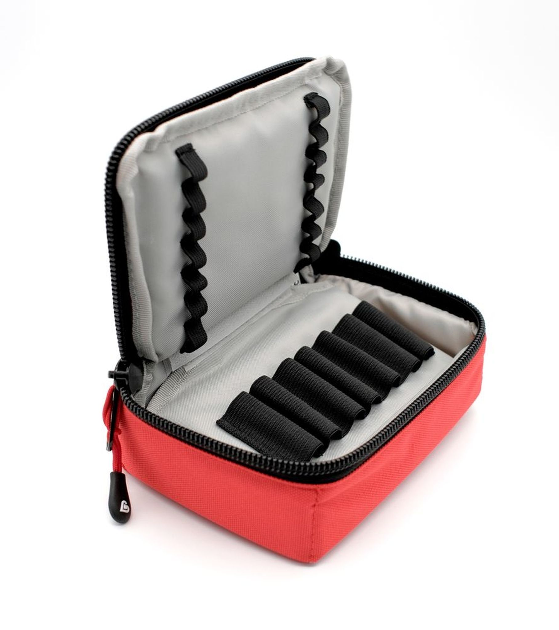 Pochette d'urgence rouge, ouverte, avec compartiments pour ampoules et boucles élastiques.