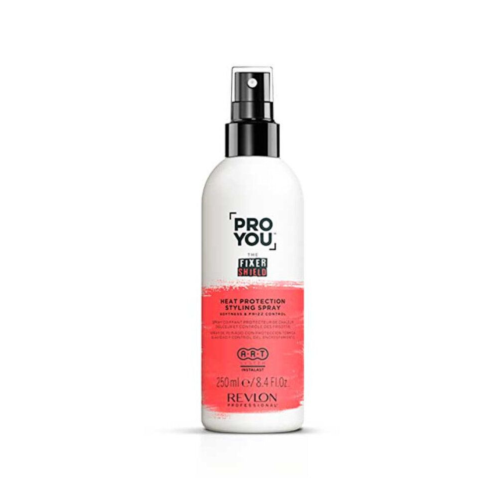 Flacon spray blanc et rouge. Inscription: PRO YOU THE FIXER SHIELD, Heat Protection Styling Spray, Revlon Professional. Tête de pulvérisation noire.