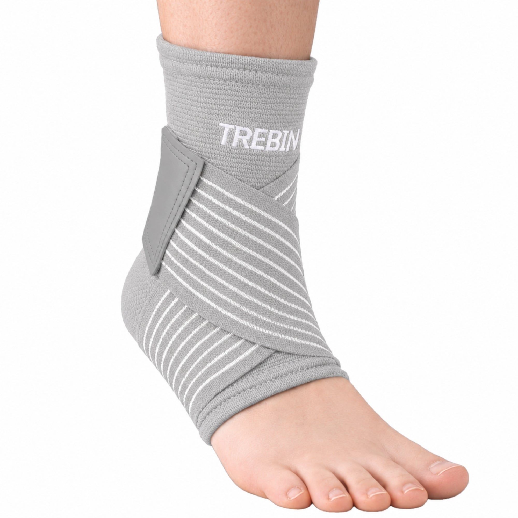 Genouillère grise avec rayures blanches et fermeture velcro. Marque : TREBIN.