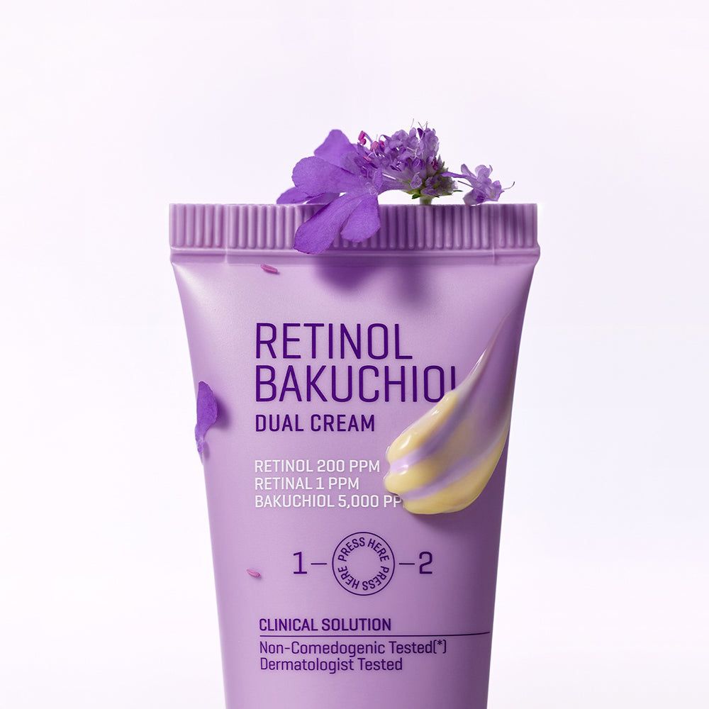 Tube violet de Retinol Bakuchiol Dual Cream orné de fleurs violettes et d'une touche de crème.
