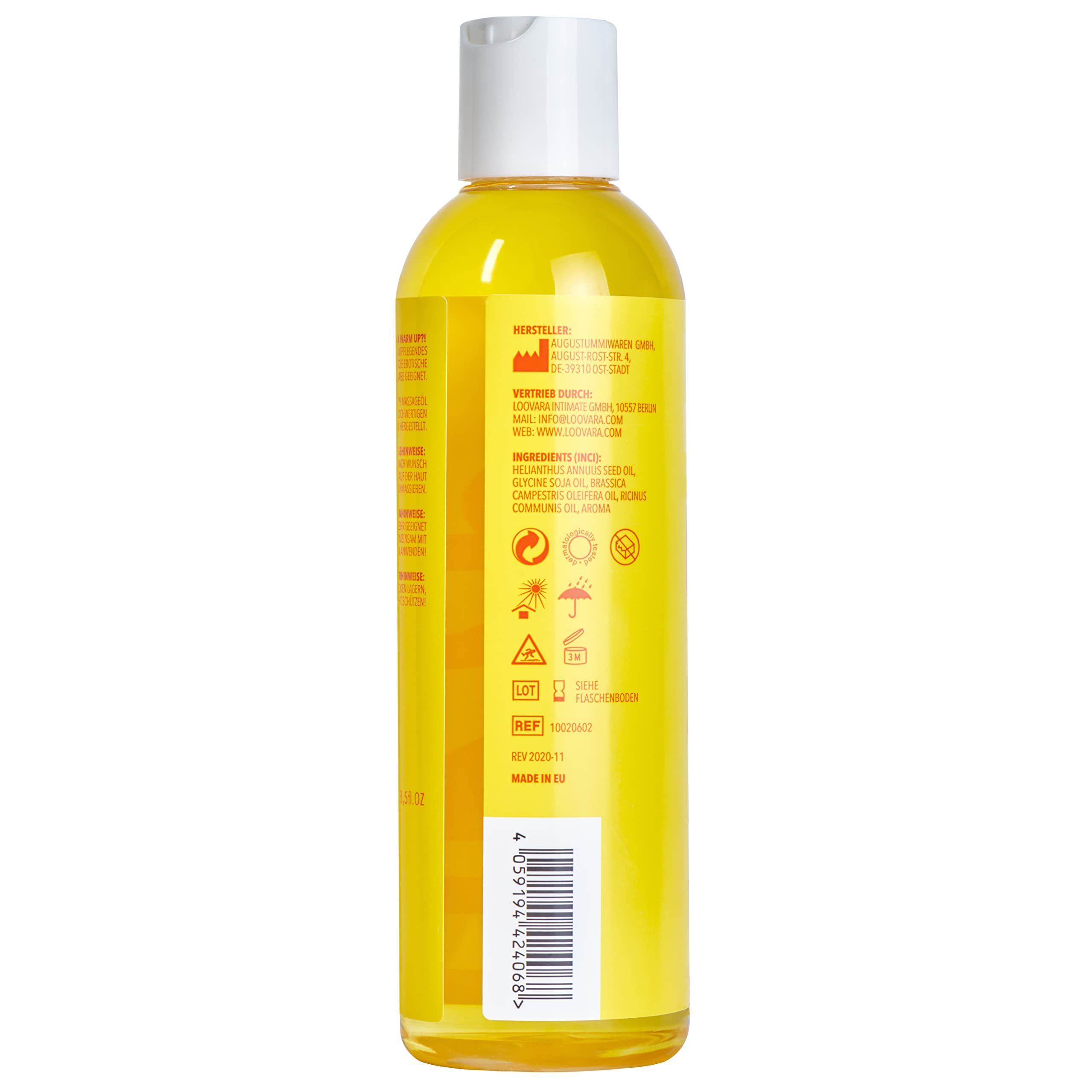 Fles Loovara Warm Up massageolie met geel etiket, omringd door oliespetters.