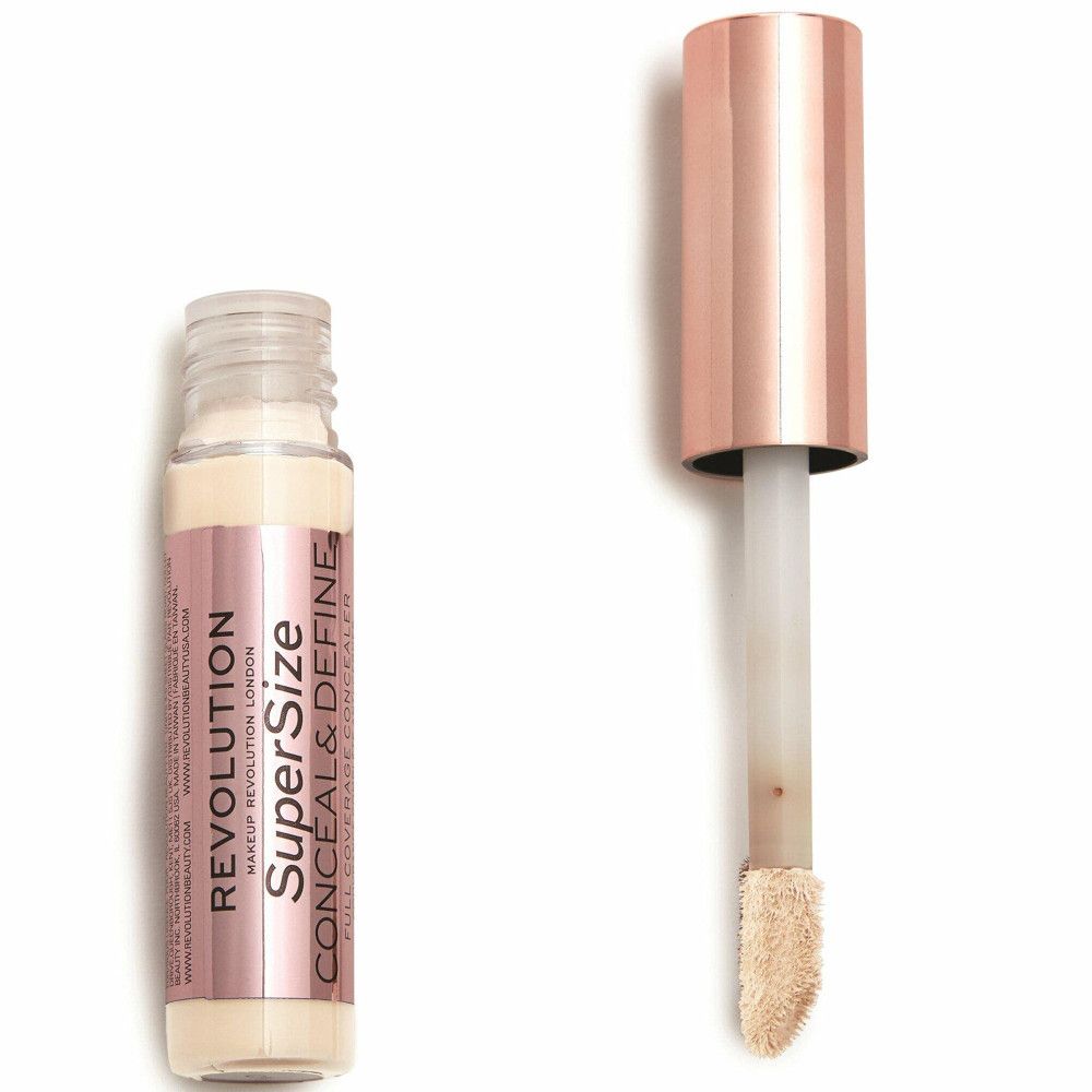 Flacon et applicateur de correcteur. Bouchon or rose. Nom du produit et marque visibles.