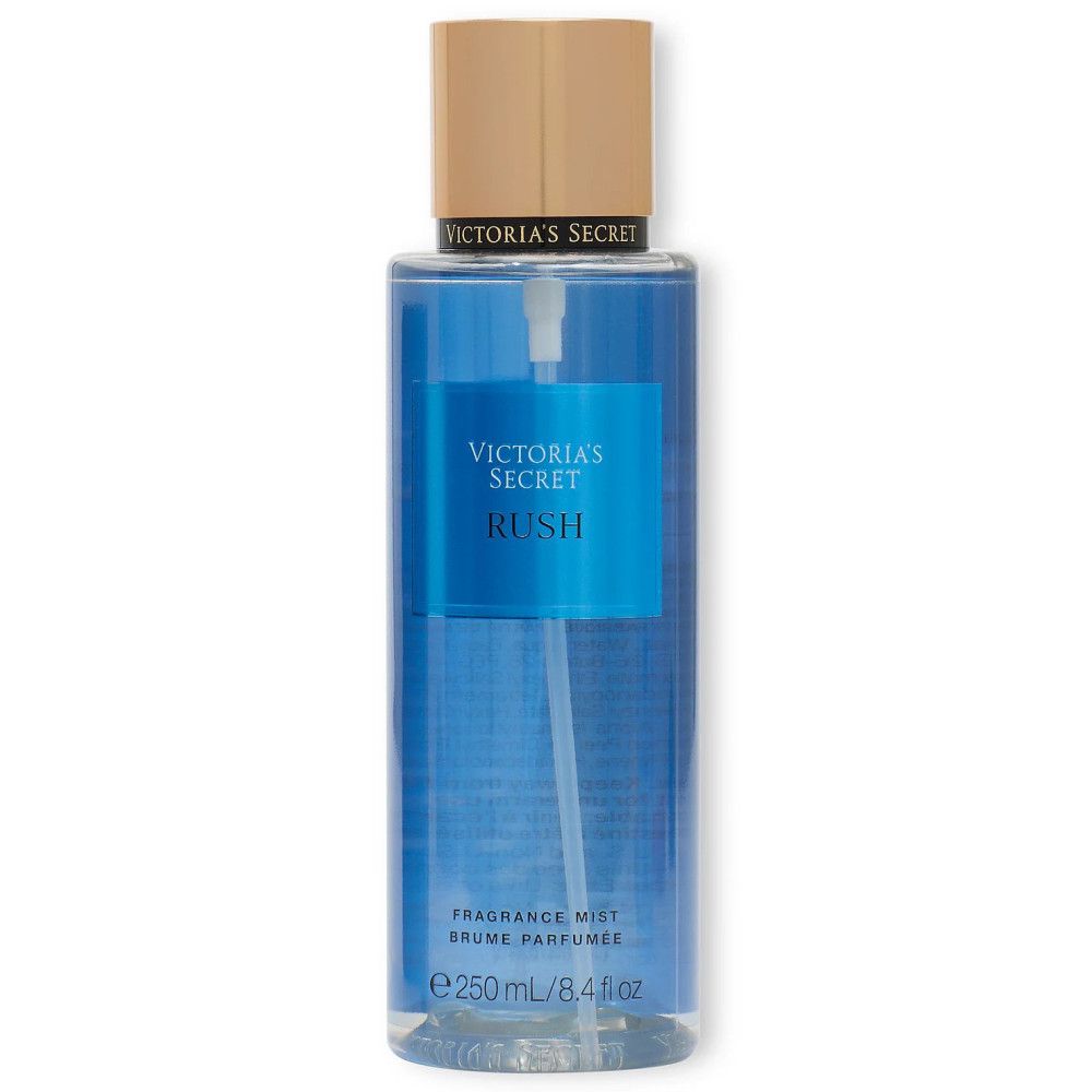 Flacon bleu avec vaporisateur et texte 'Victoria's Secret Rush'. Étiquette avec 'Fragrance Mist'.