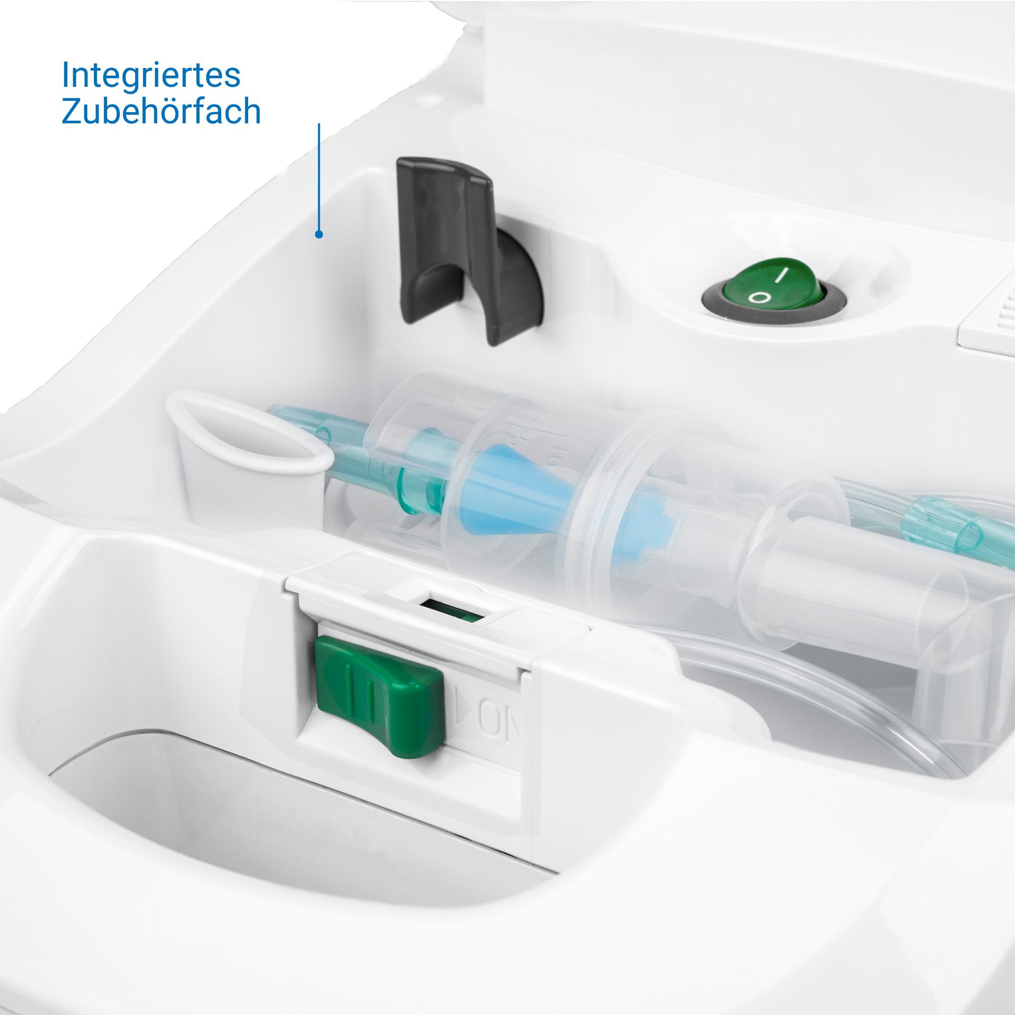 Vue détaillée de l'inhalateur Medisana : compartiment à accessoires intégré avec masques, tuyaux et embouts. Bouton marche/arrêt vert.