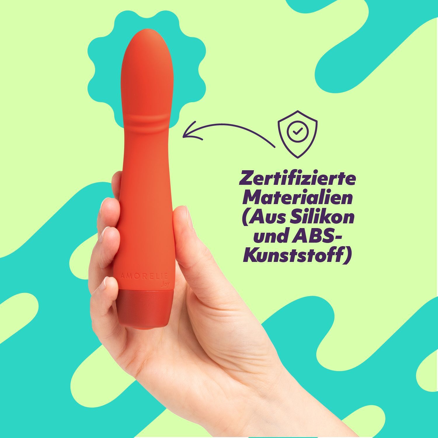Vibrateur rouge dans la main. Texte: Matériaux certifiés (en silicone et plastique ABS).