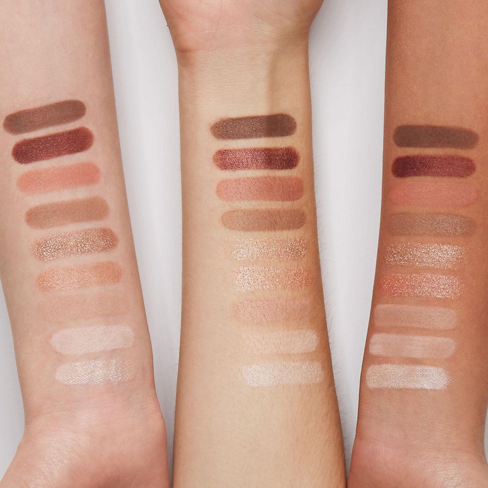 Trois bras avec des échantillons de fards à paupières dans différentes nuances de rose et de marron. Différents tons de peau.