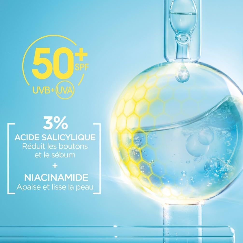Liquide dans un ballon en verre avec FPS 50+ UVB+UVA, 3% d'acide salicylique et niacinamide.