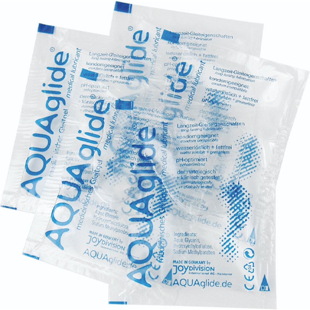 Trois sachets individuels transparents avec texte "AQUAglide". Texte : "lubrifiant médical". Emballage individuel avec texte bleu.