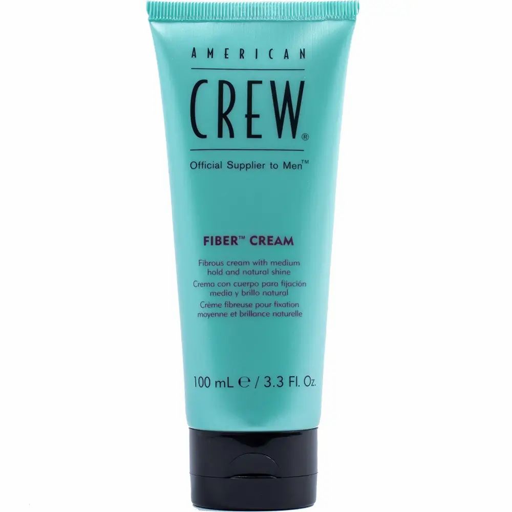 Lichtblauwe tube met zwarte dop. Opschrift: American Crew, Fiber Cream. Product op witte achtergrond.