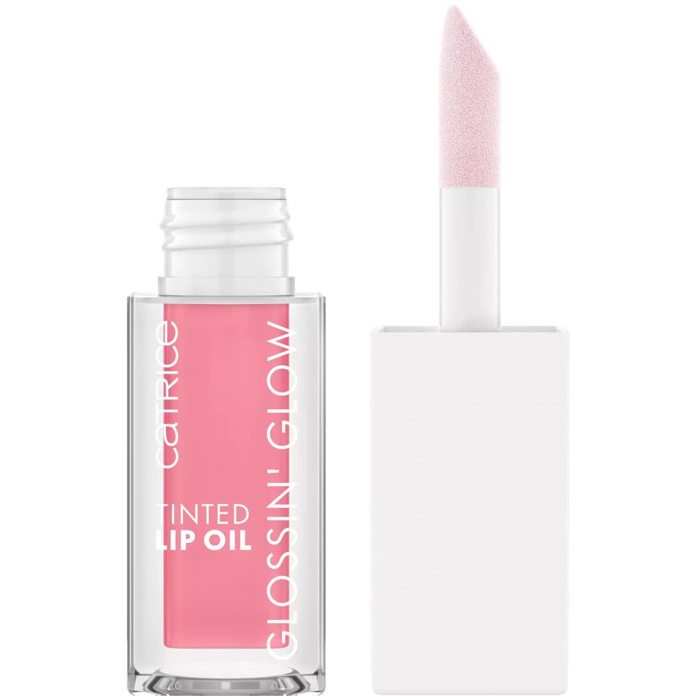 Getinte lipolie in glazen fles met applicator. Roze vloeistof zichtbaar. Tekst: Catrice, Glossin' Glow, Tinted Lip Oil.