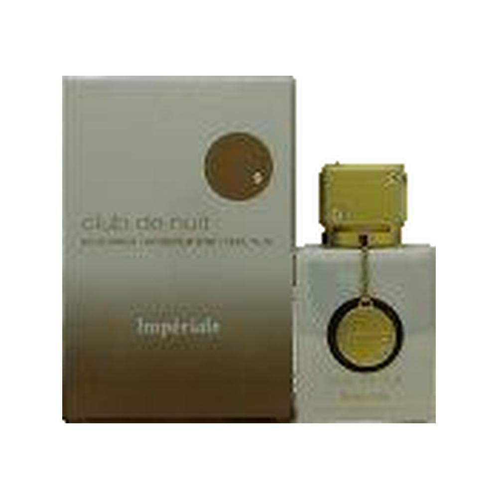 Parfumfles en verpakking. Vierkante witte fles met gouden dop. Rechthoekige beige verpakking met gouden cirkel.