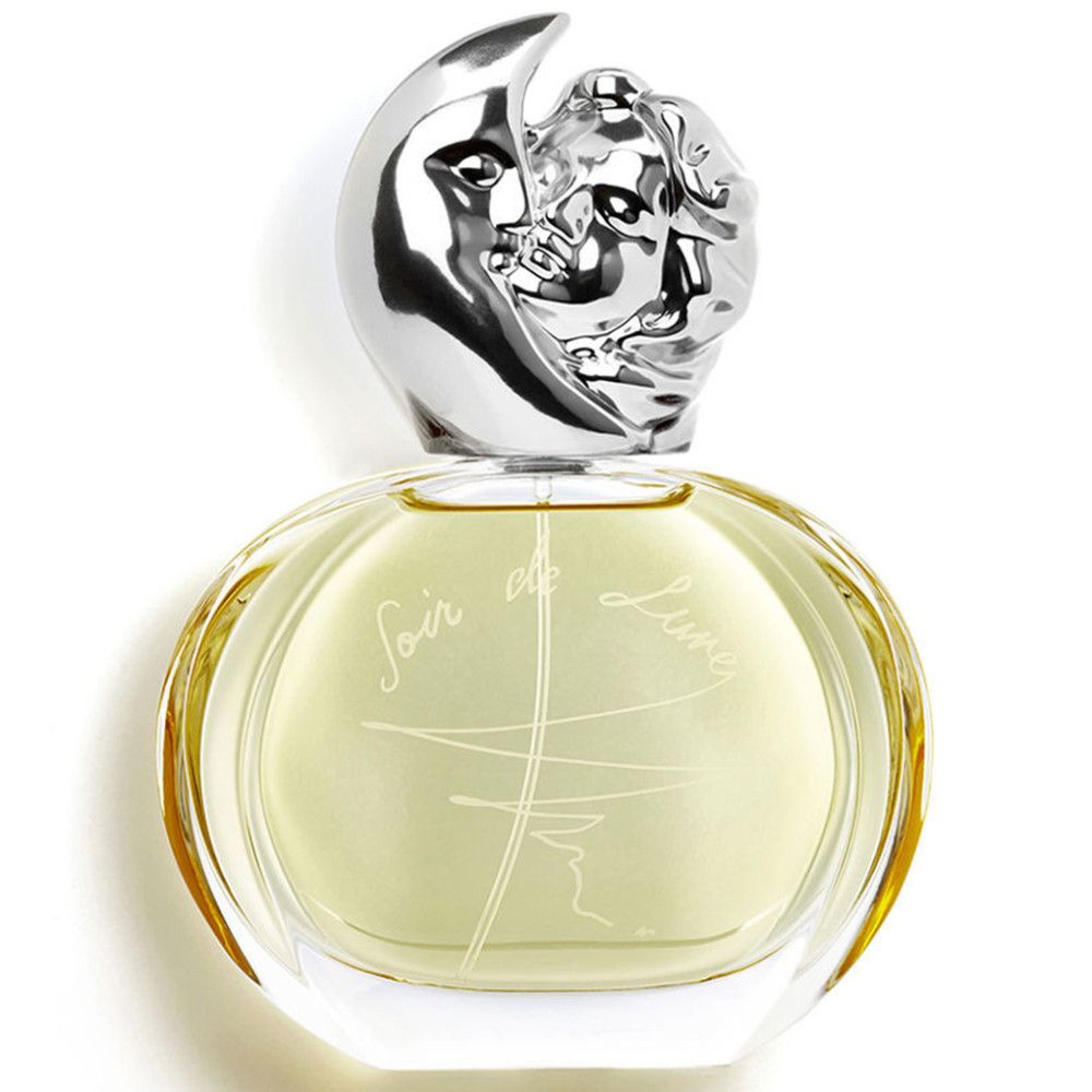 Flacon rond en verre avec bouchon argenté en forme de lune et visage féminin. Inscription "Soir de Lune".