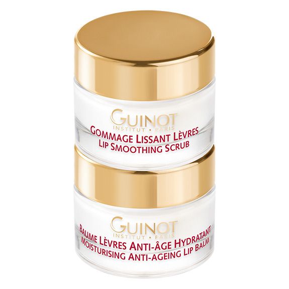Twee crème potjes, op elkaar gestapeld. Gouden deksels, transparante containers. Opschriften: Guinot, Gommage Lissant Lèvres, Baume Lèvres Anti-Âge Hydratant.