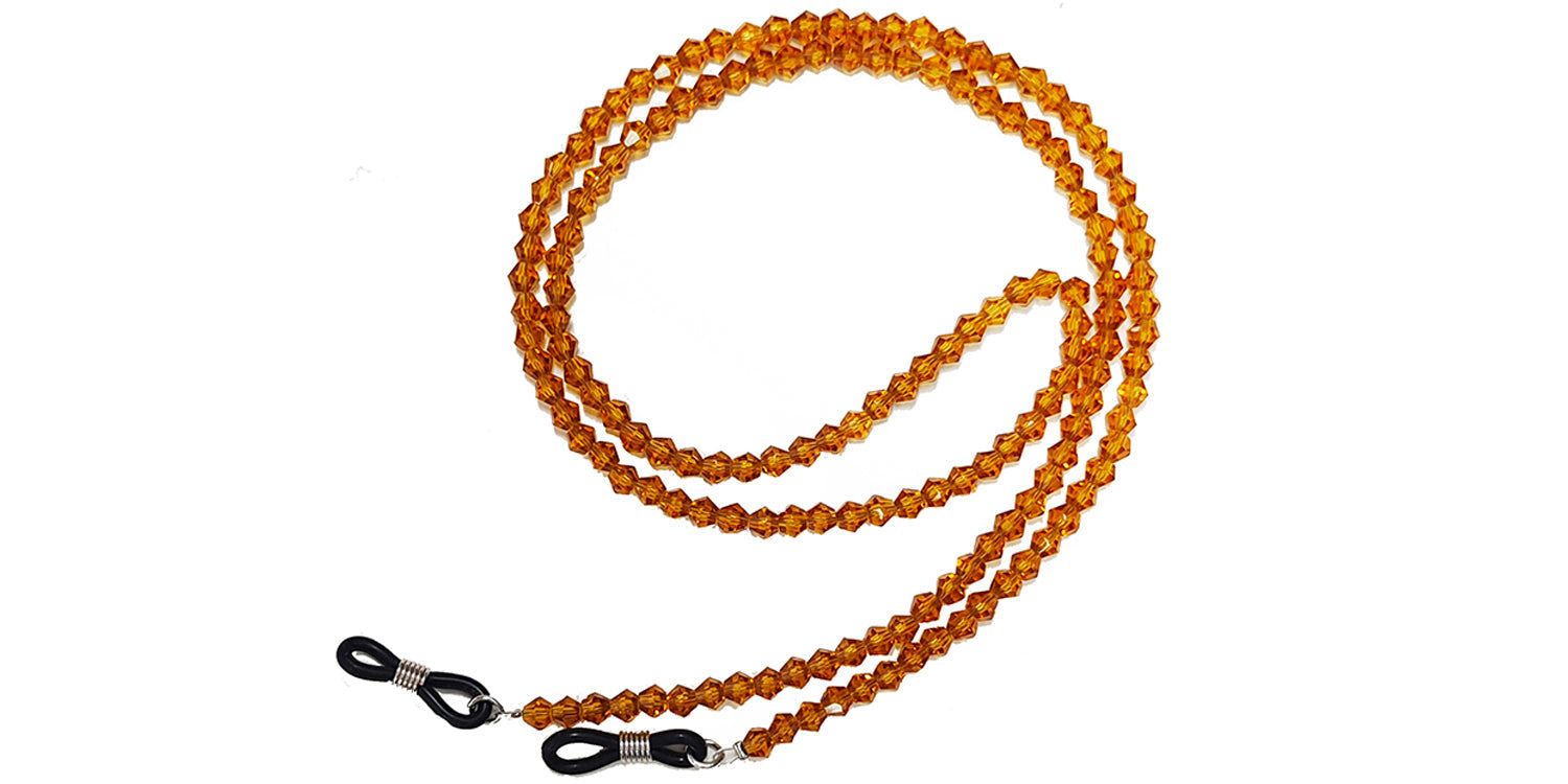 Cordon à lunettes avec perles ambrées. Boucles en silicone noir pour fixation sur branches de lunettes.