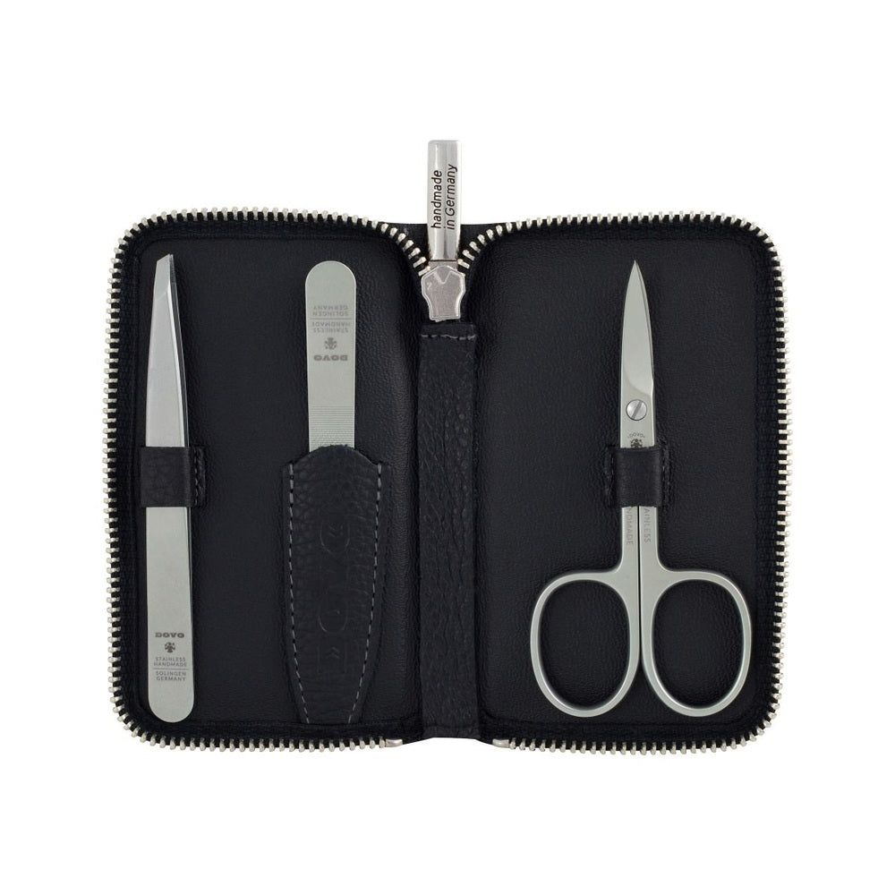 Étui de soins DOVO Solingen avec instruments de manucure : pince à épiler, lime à ongles, ciseaux.