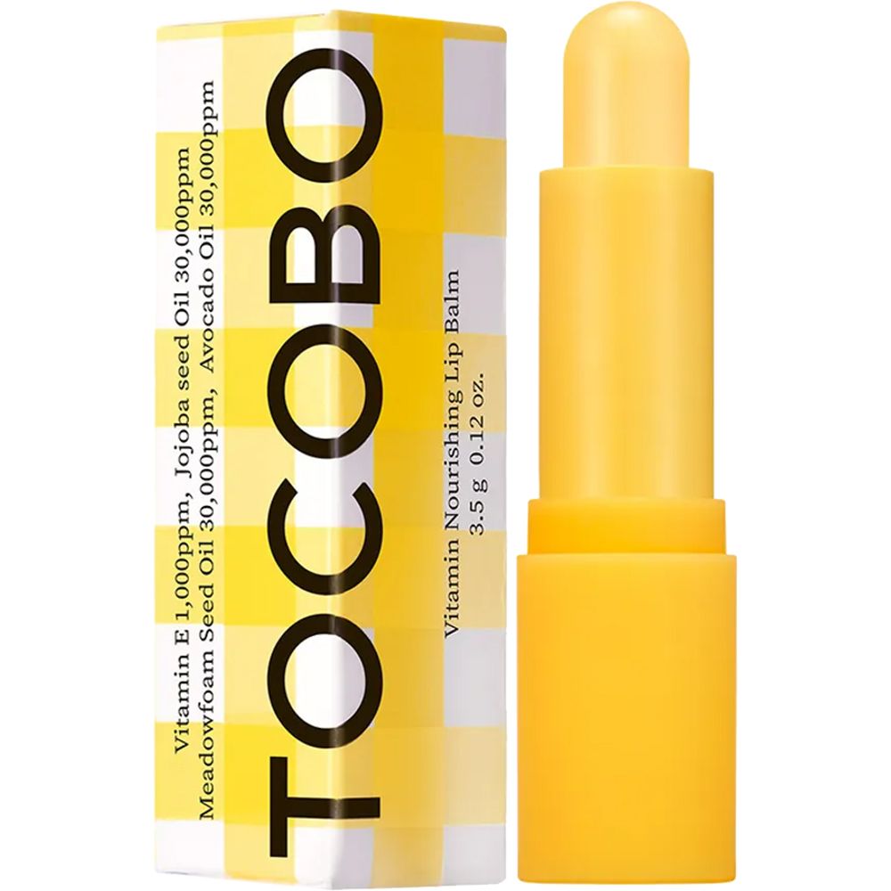 Gele lippenbalsem-stick naast verpakking. Opschrift: TOCOBO, Vitamin Nourishing Lip Balm, 3.5g 0.12 oz.