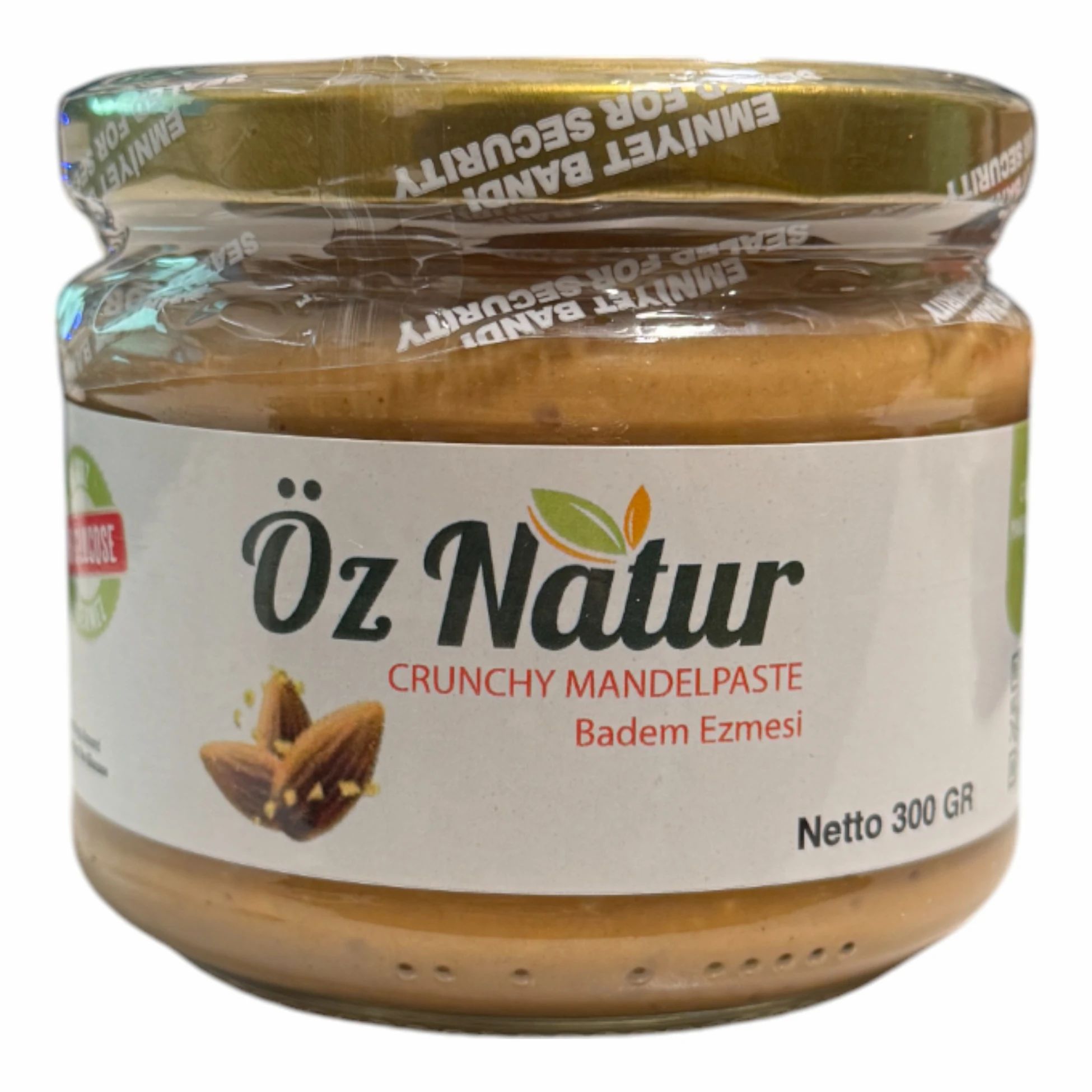 Pot amandelpasta. Opschrift: Öz Natur, Crunchy Mandelpaste, Badem Ezmesi. Zegel: Emniyet Bandi. Netto 300 GR.