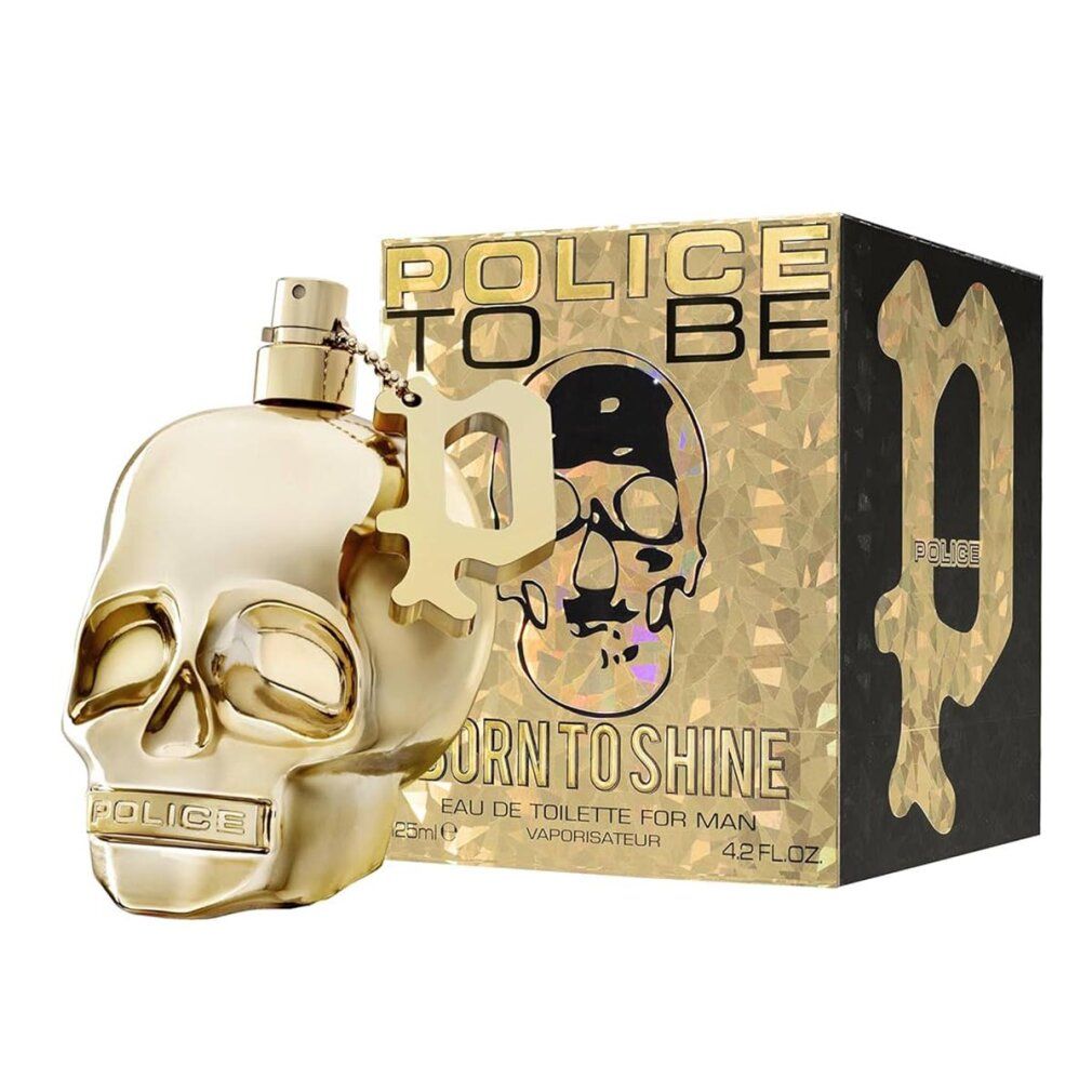 Flacon de parfum doré en forme de tête de mort avec sa boîte. Inscription "Born to Shine".