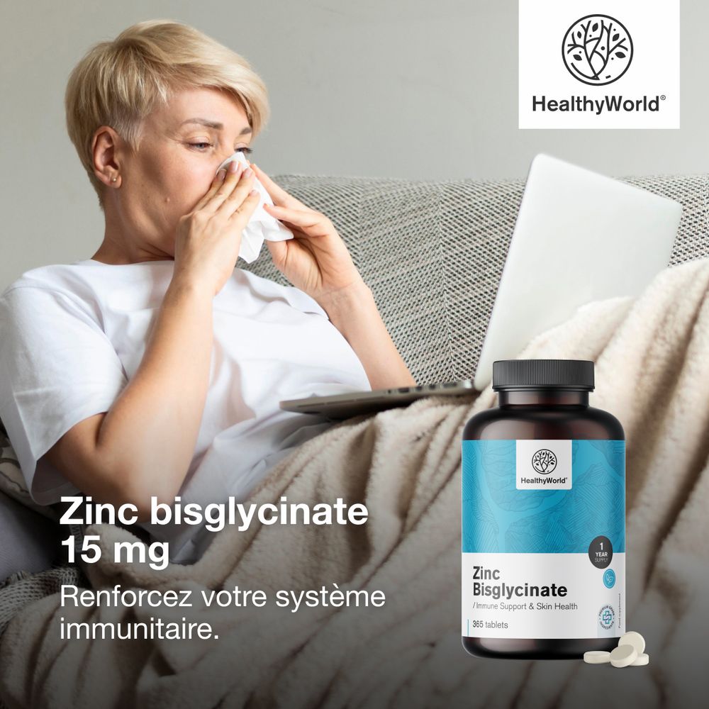 Femme avec mouchoir, ordinateur portable et flacon de Zinc bisglycinate. Inscription: HealthyWorld, 15 mg. Texte: Renforcez votre système immunitaire.