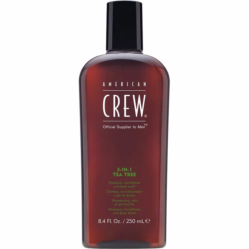 Bruine fles met zwarte dop. Opschrift: AMERICAN CREW, 3-IN-1 TEA TREE. Shampoo, conditioner & body wash.