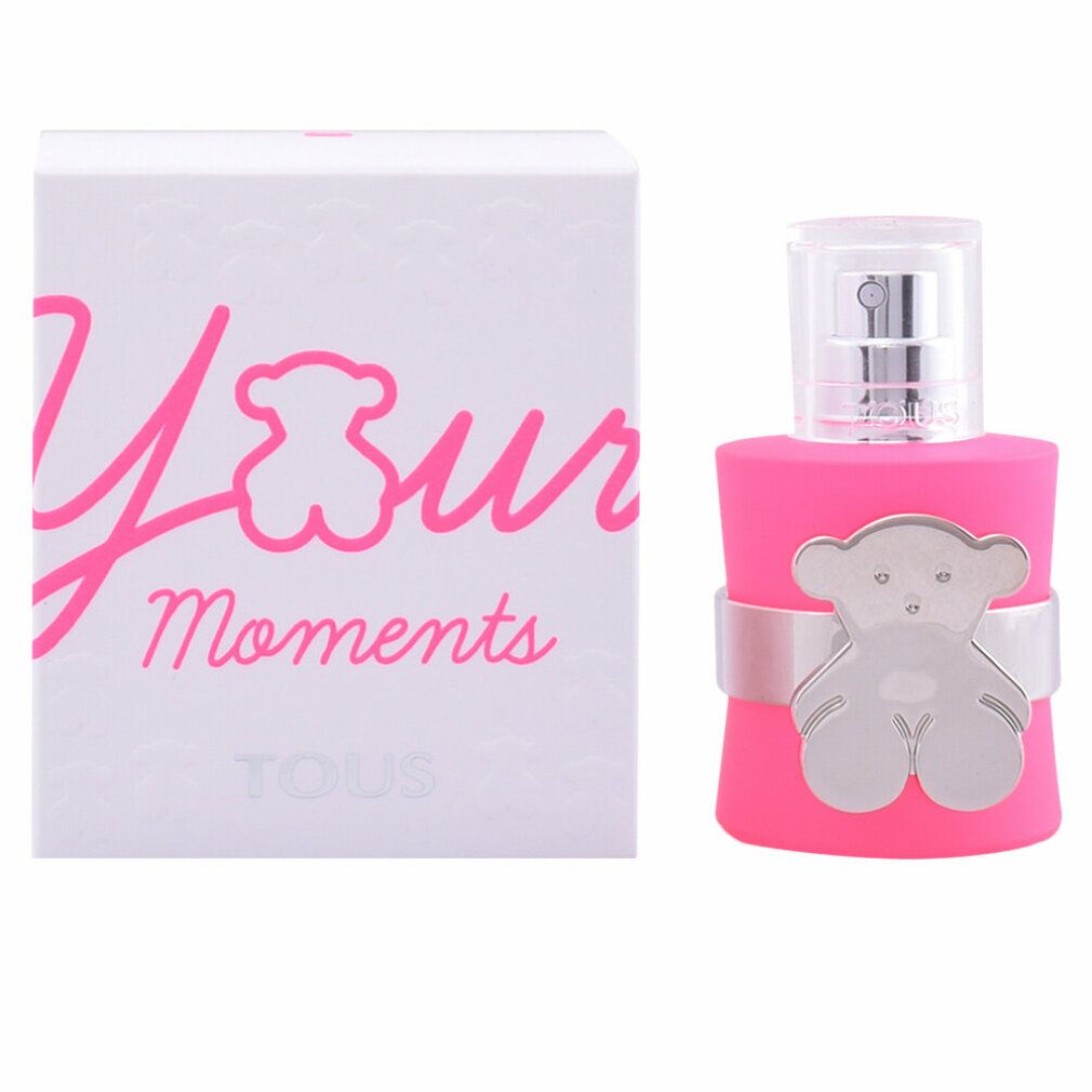 Roze fles met zilveren beerdecoratie en witte verpakking met opschrift "Your Moments".