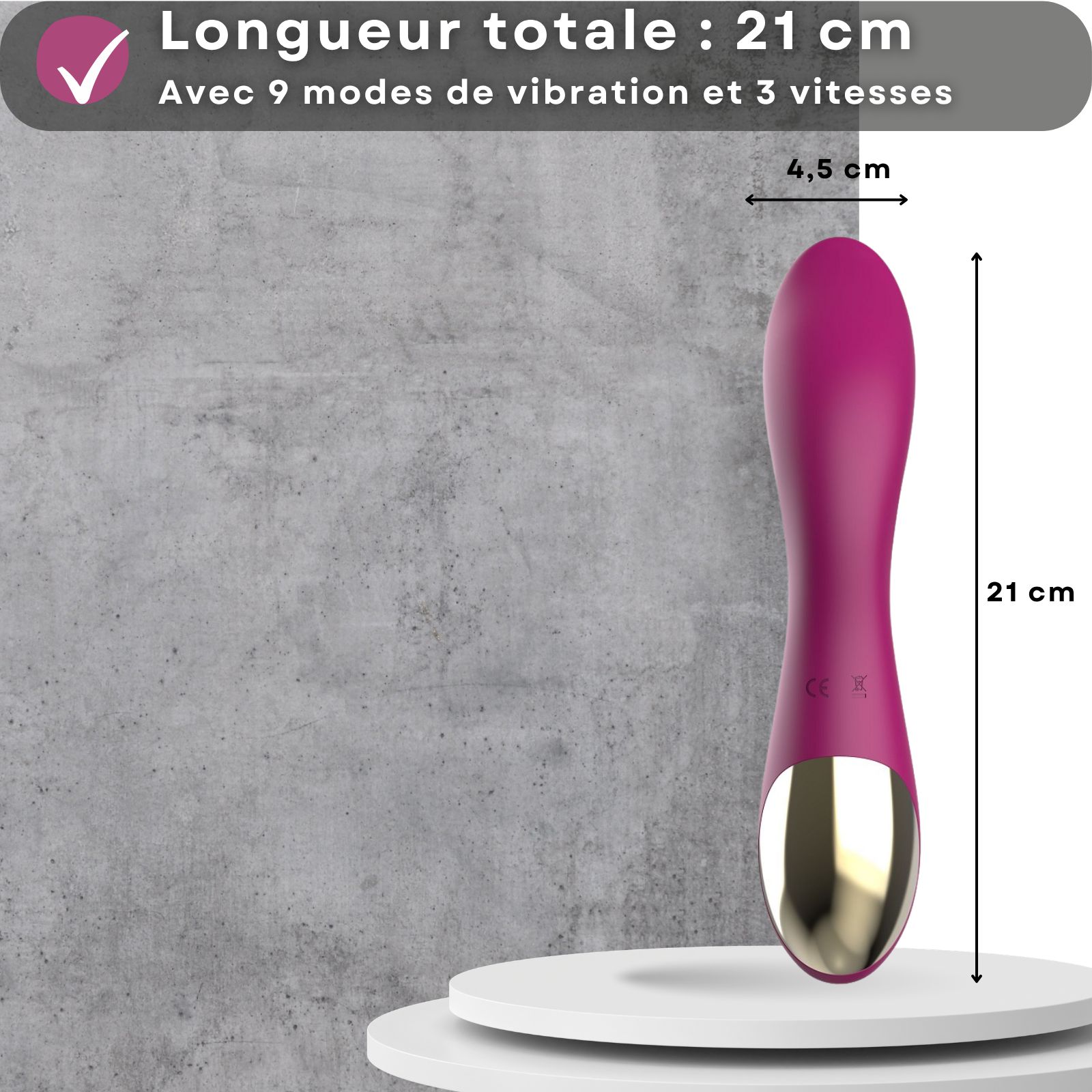 Vibrateur rose. Longueur 21 cm, diamètre 4,5 cm. Sur socle. Accent doré à la base.