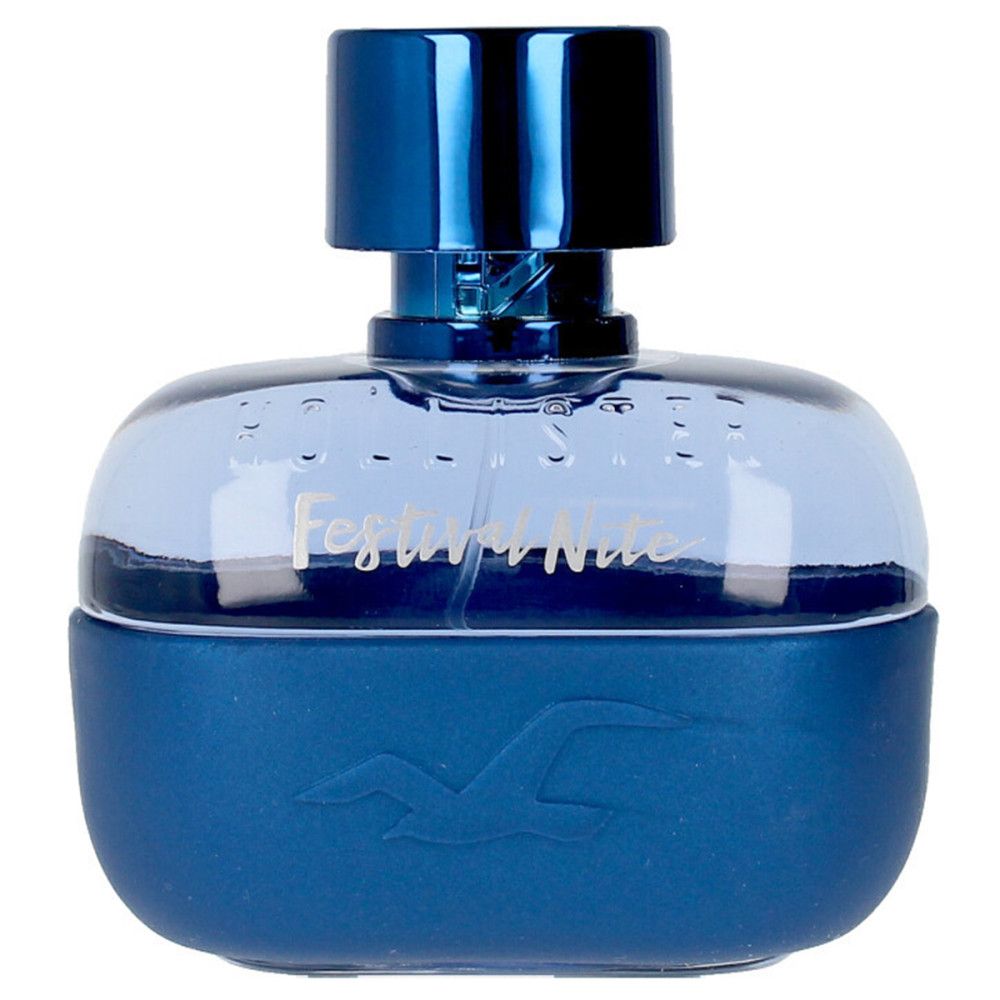 Flacon de parfum bleu. Le flacon indique "Festival Nite". Le flacon est de forme ronde et a un bouchon bleu.