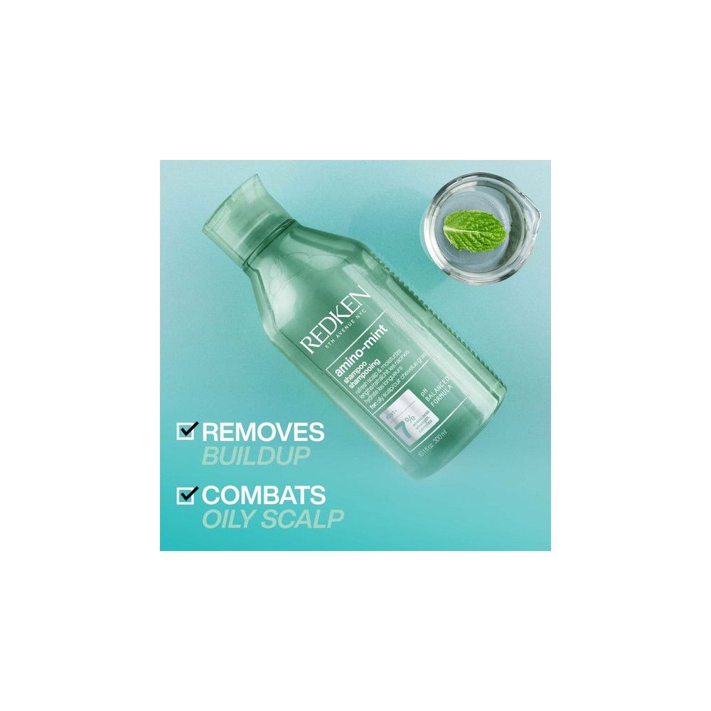 Groene Redken Amino Mint shampoo fles. Bevat een muntblad. Tekst: Verwijdert ophoping, bestrijdt vette hoofdhuid.