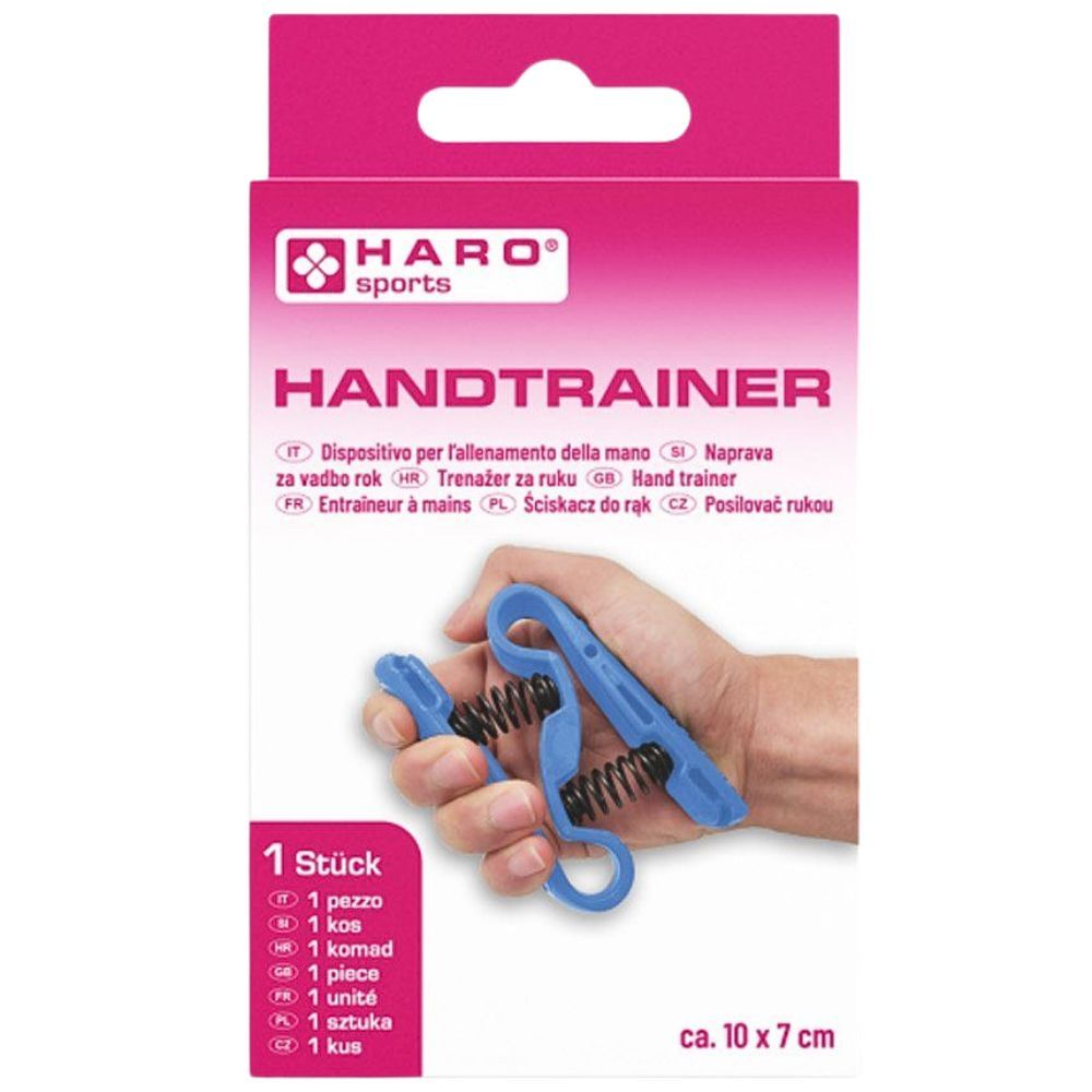 Haro Handtrainer dans son emballage. Appareil d'entraînement bleu dans une main. Emballage rose avec nom et logo. Dimensions env. 10 x 7 cm.